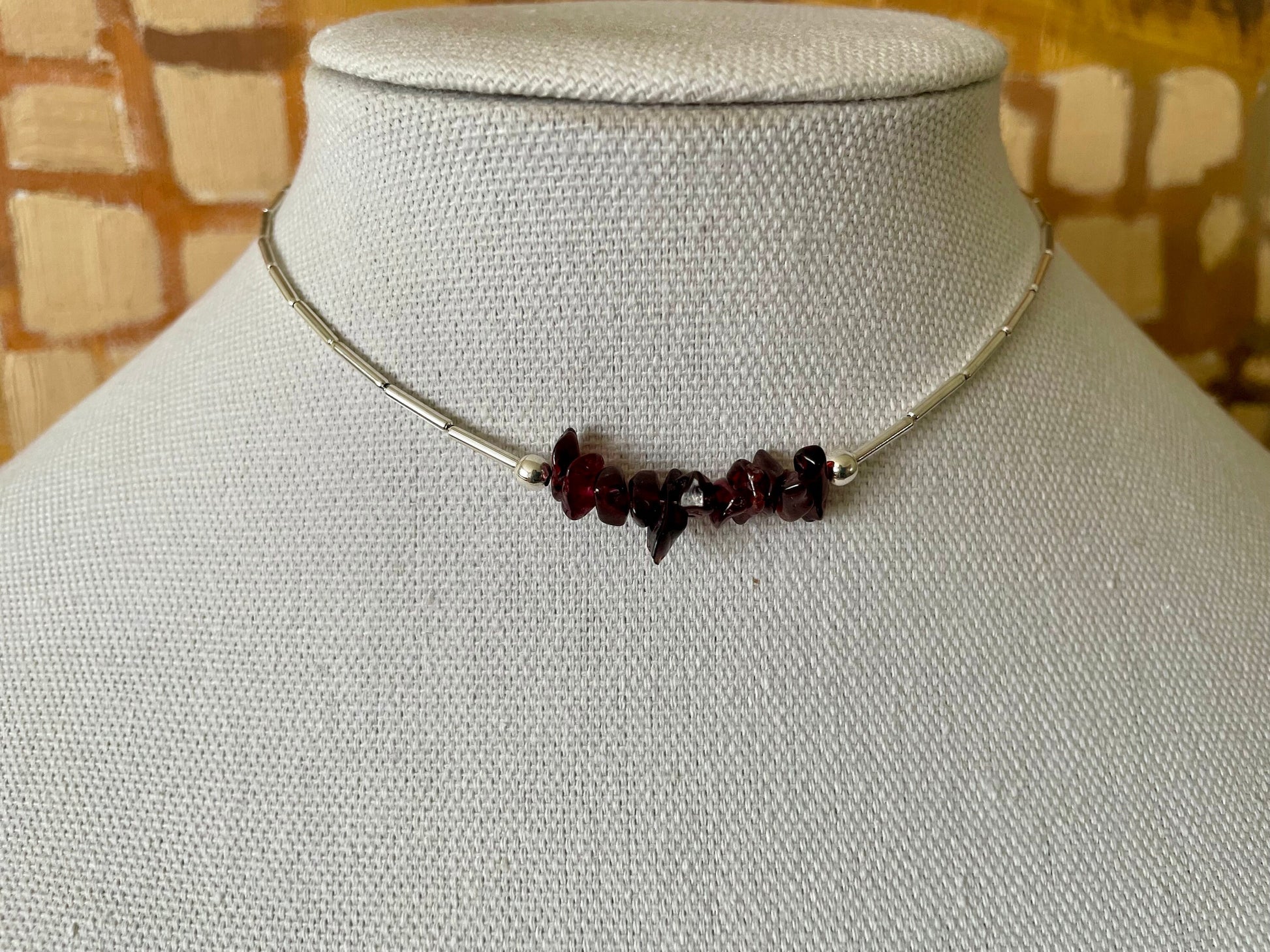 Garnet and gold or silver collarbone-length necklaces. Simple & Elegant