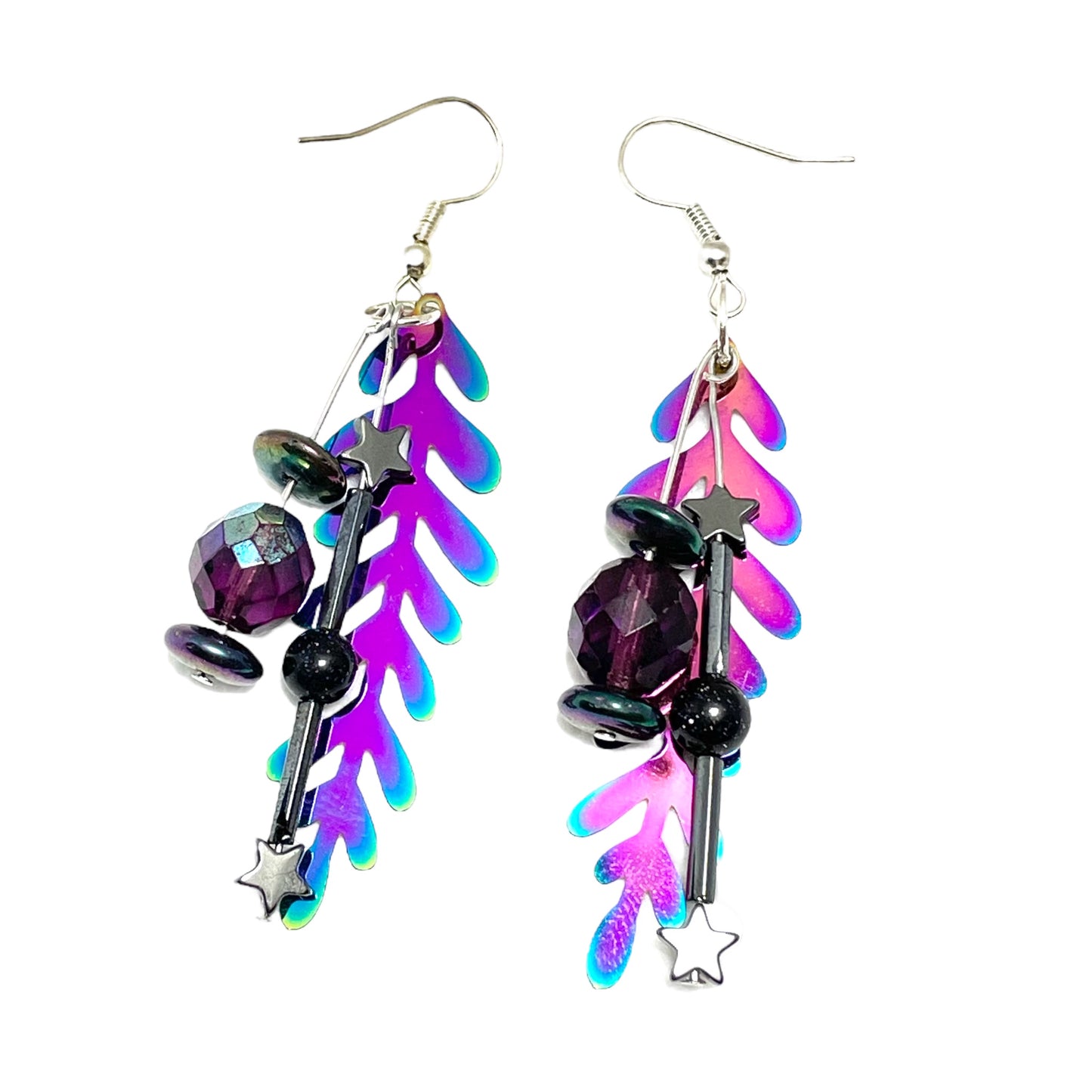 Colorful rainbow dangle earrings that are handmade and feature hematite stone stars and a metal rainbow leaf